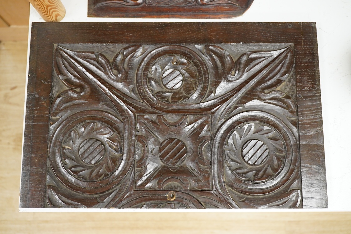 Three 18th century and later carved oak panels, one carved with a coronet, largest 46cm wide